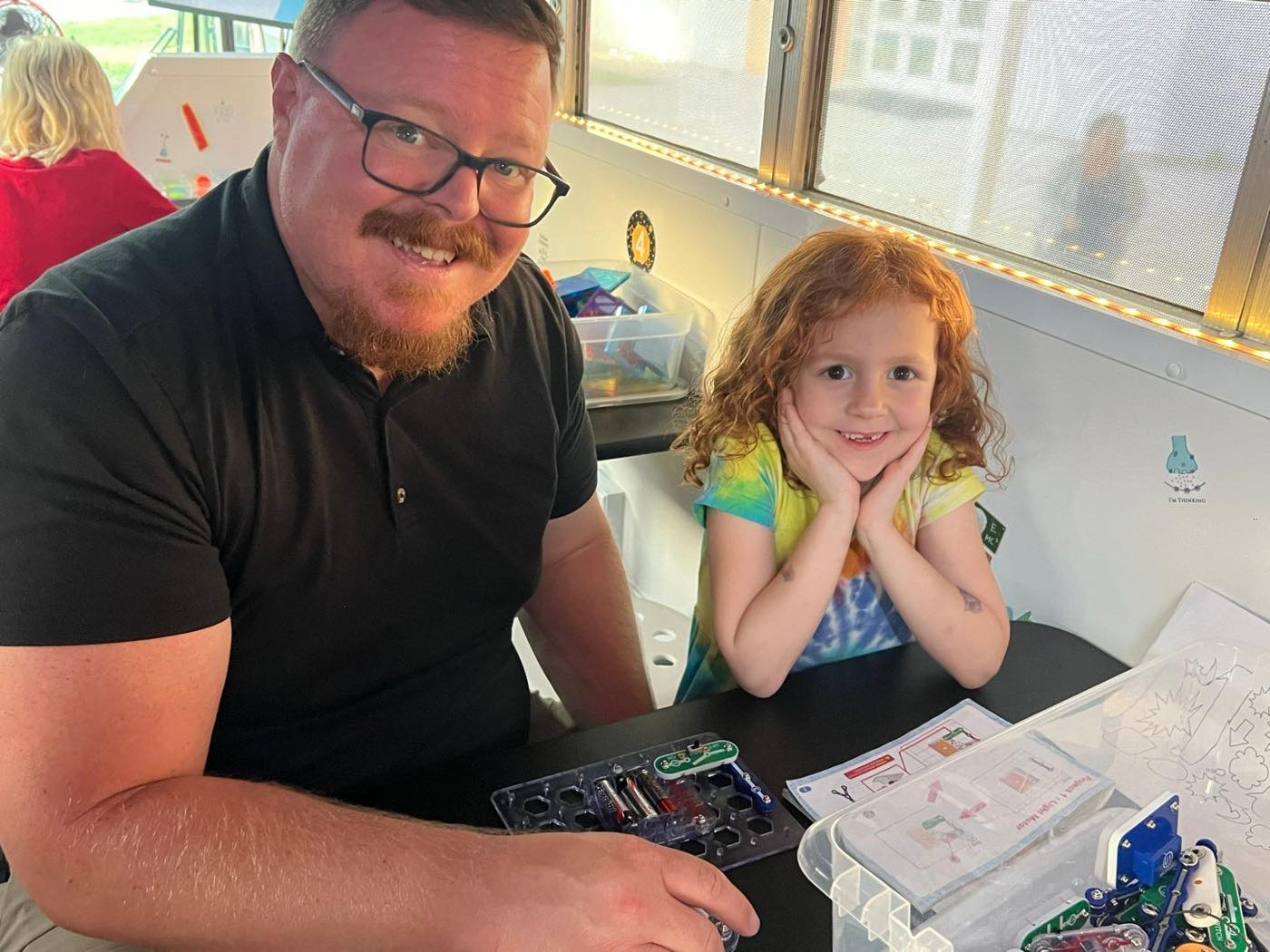 An adult and a student completing a snap-circuit build together