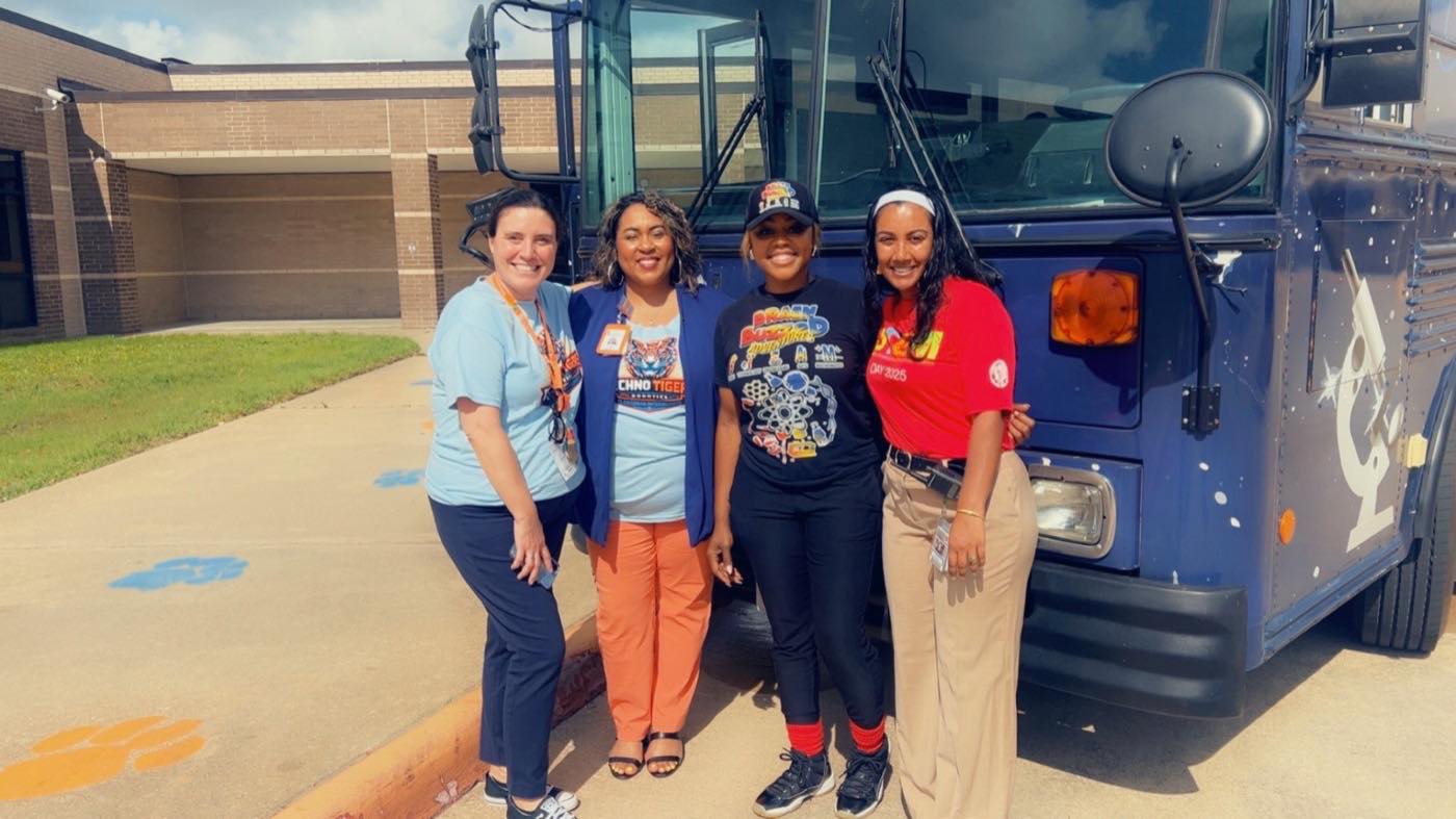 The BrainBuzzed team with campus staff in front of the Mobile STEAM Lab on a district visit