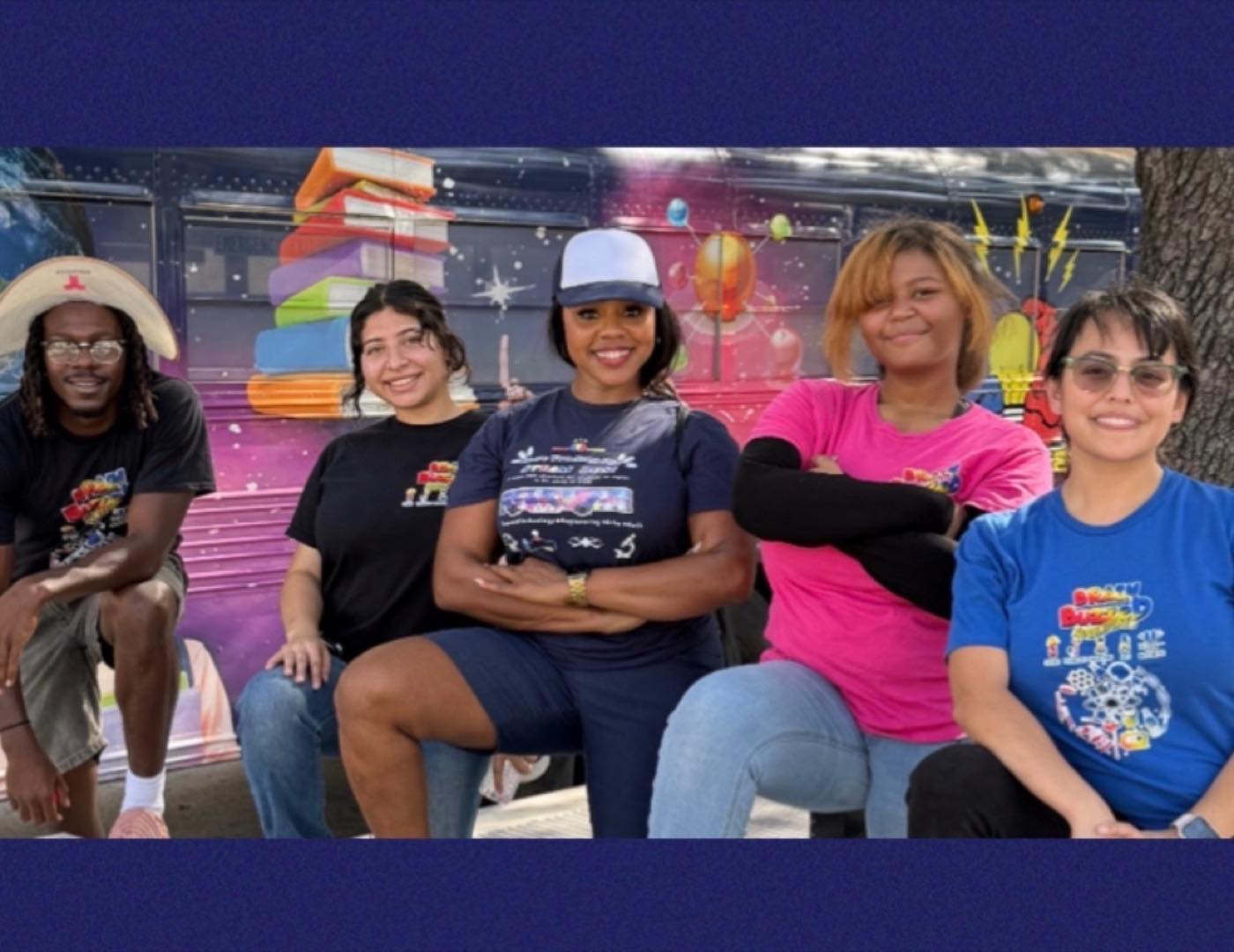 Five members of the BrainBuzzed team seated in front of the bus